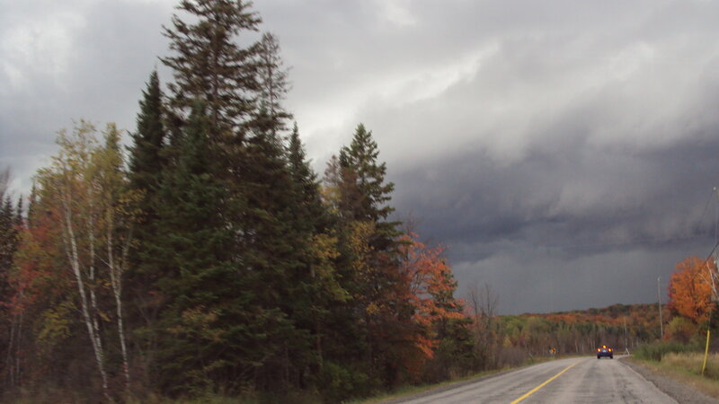 Car on Road under Storm Clouds — Gray