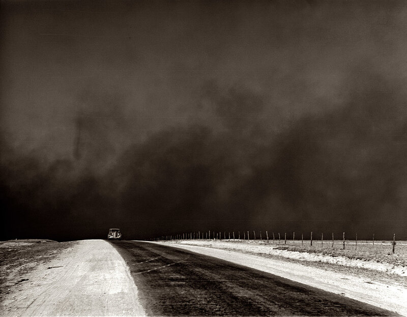 Car on road under storm clouds