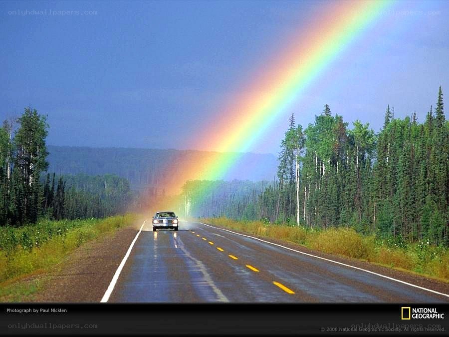 Car on road with rainbow