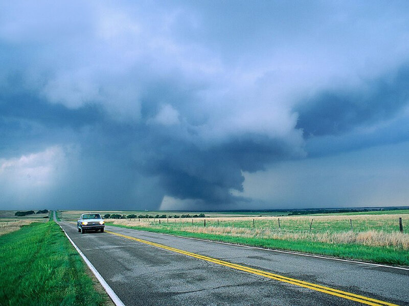Car on road with storm cloud