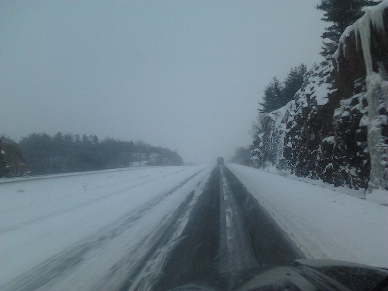 Car on Snowy Highway