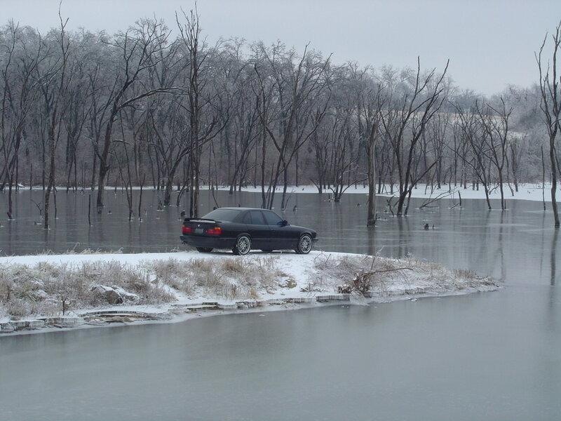 Car on snowy lake shore
