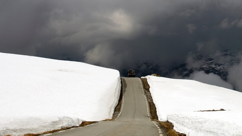 Car on Snowy Mountain Road — White, Dramatic