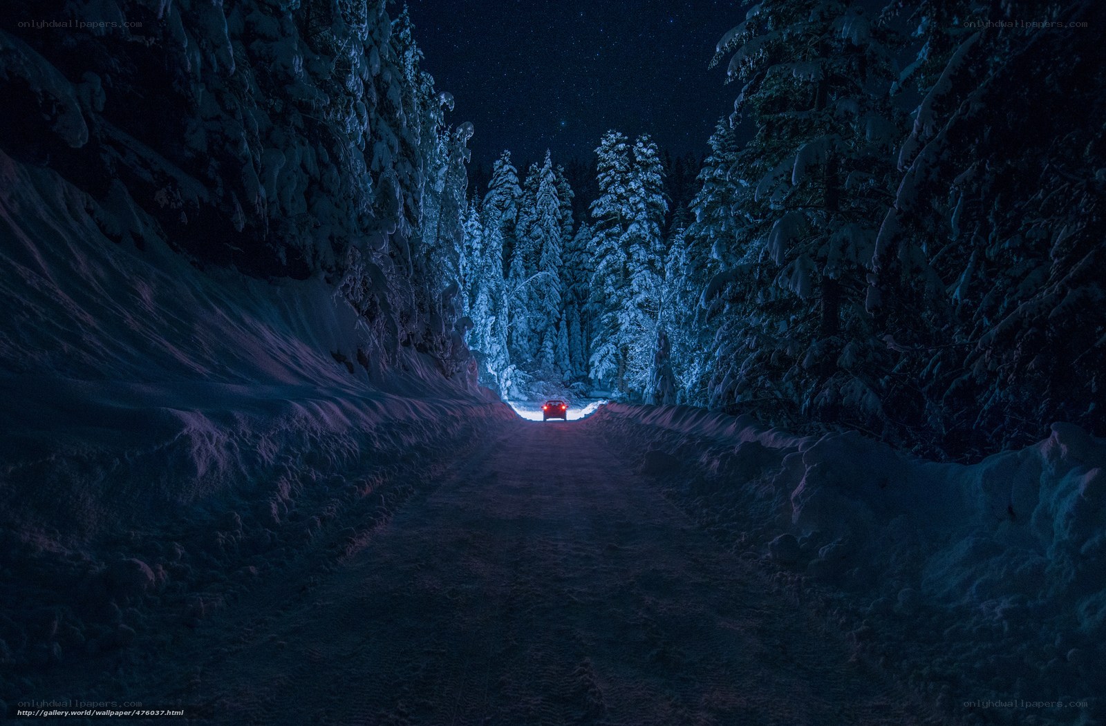 Car on snowy road at night