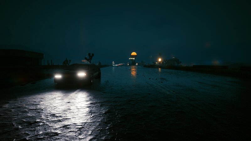 Car on Wet Road at Night