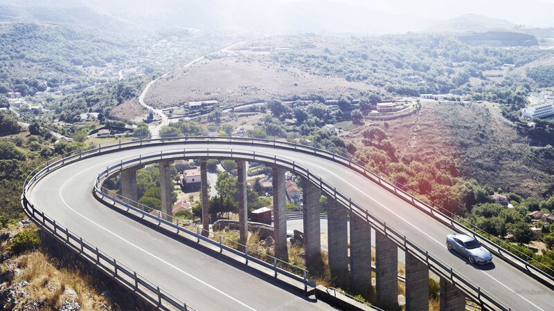 car on winding bridge