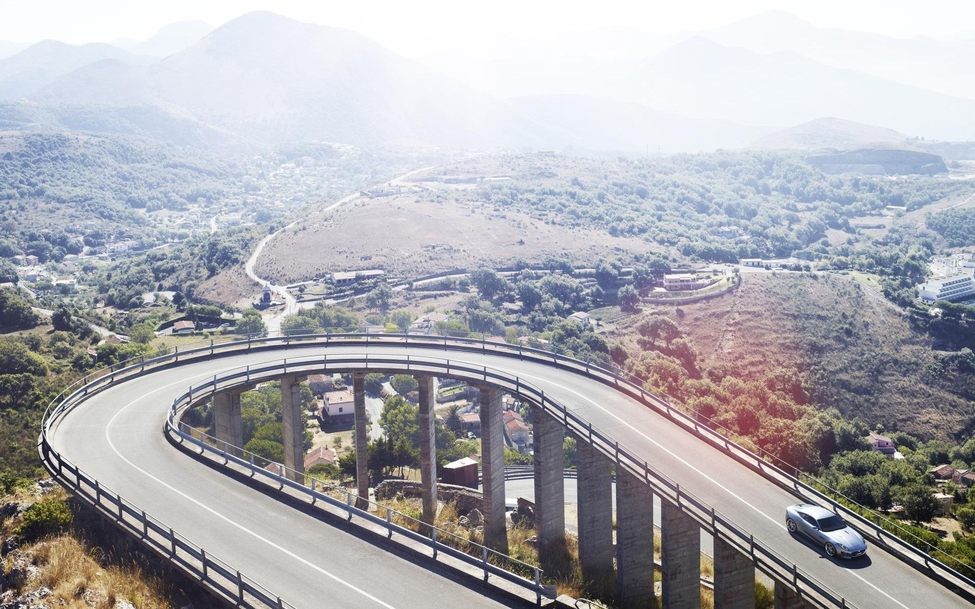 Car on winding mountain bridge