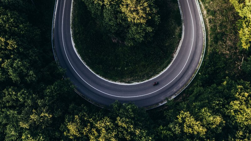 Car on Winding Road — Green, Serene, Afternoon