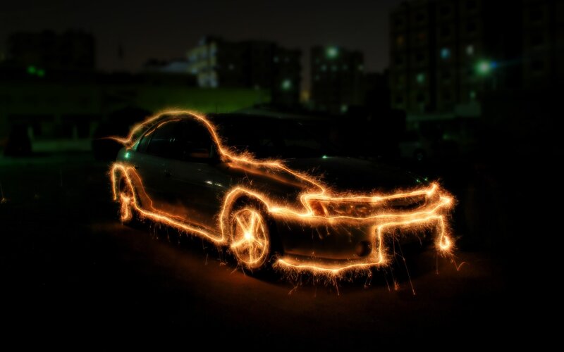 Car outlined in sparks at night