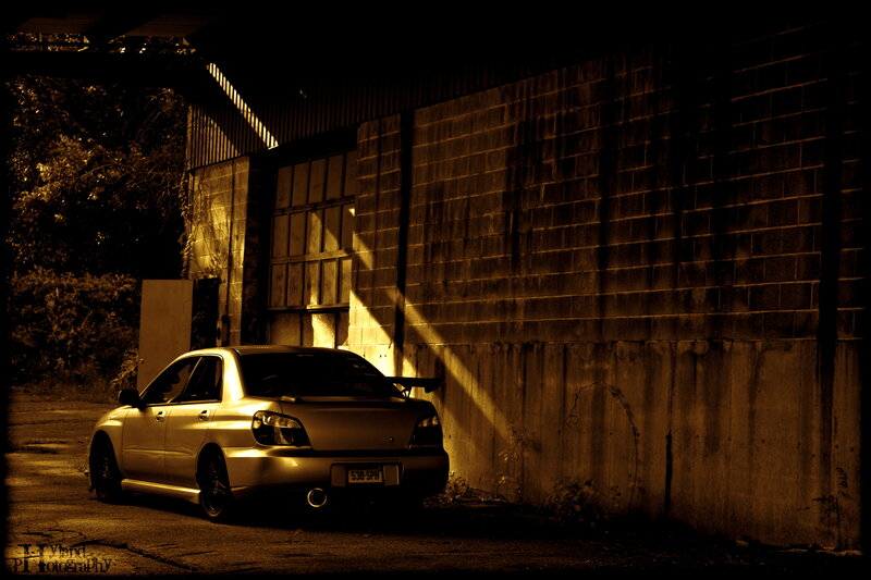 car parked in alley at dusk