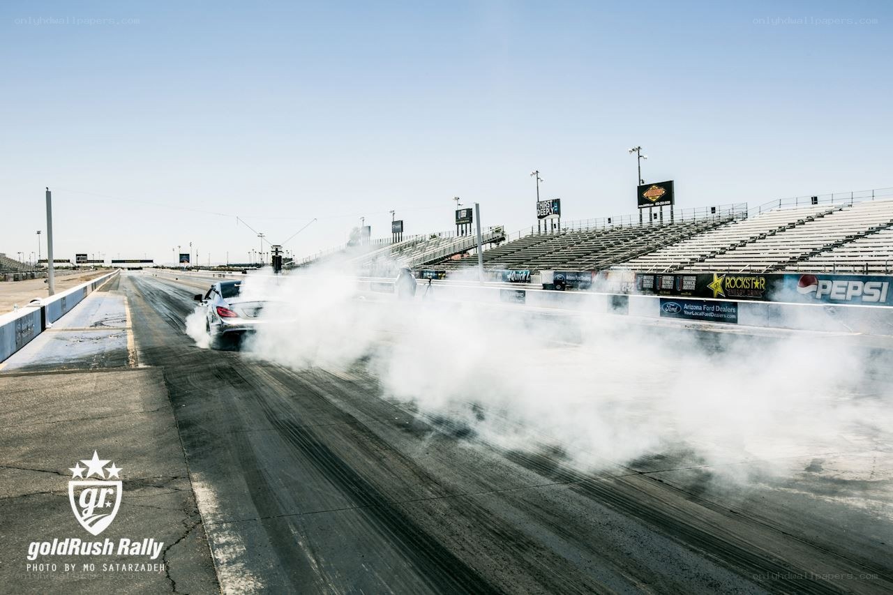 Car performing burnout at drag strip