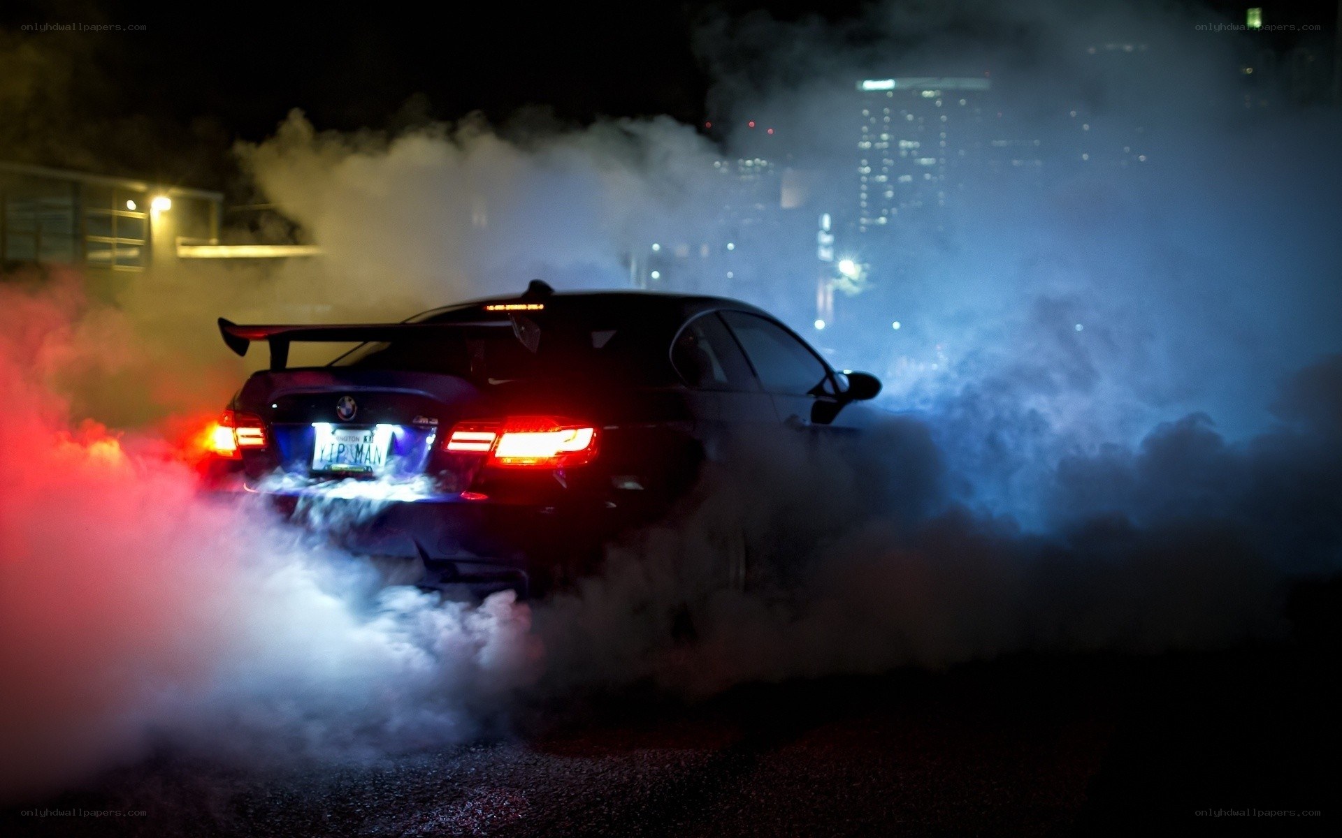 Car performing burnout at night