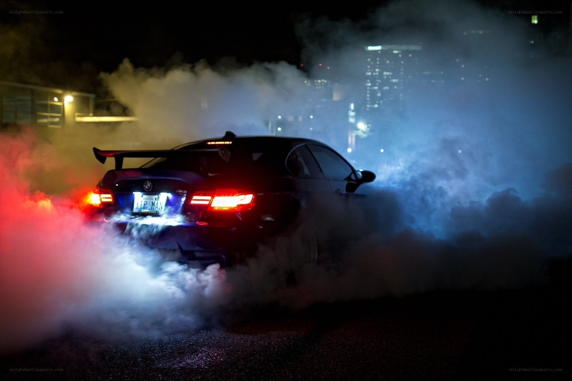 Car performing burnout at night