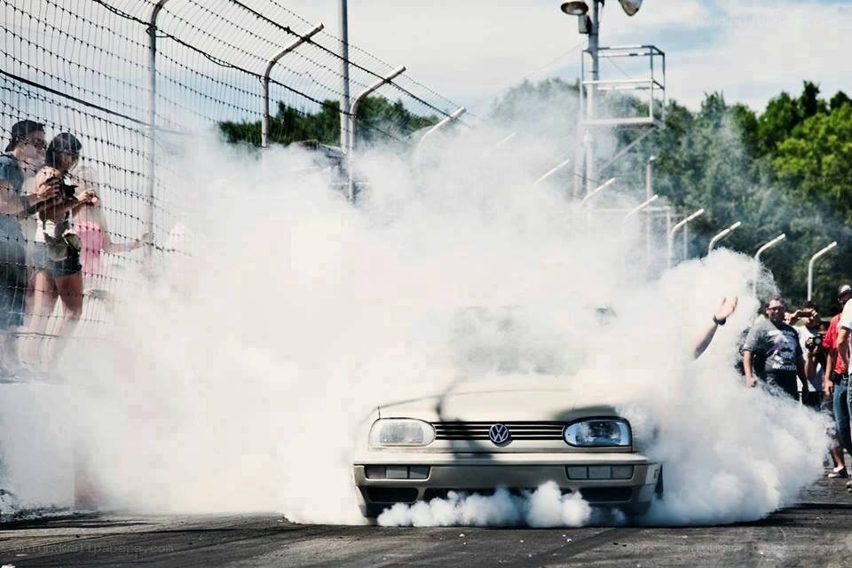 Car performing burnout at racetrack