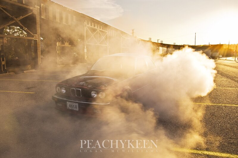 Car performing burnout at sunset