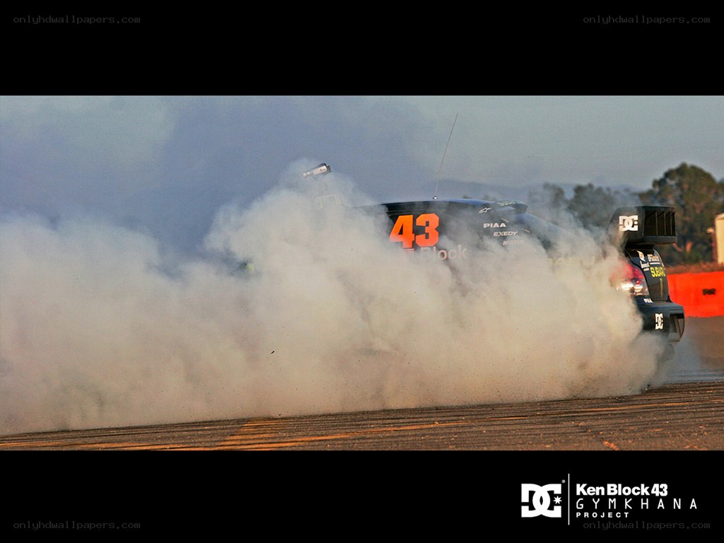 car performing burnout on track