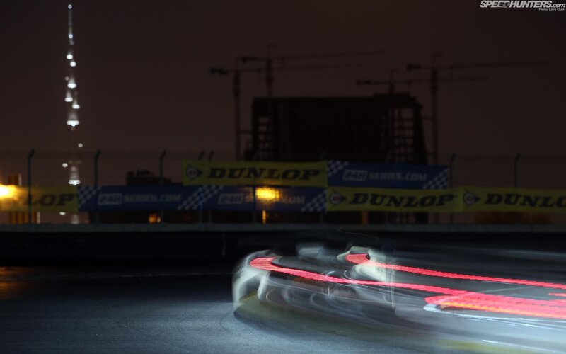 Car racing at night with light trails