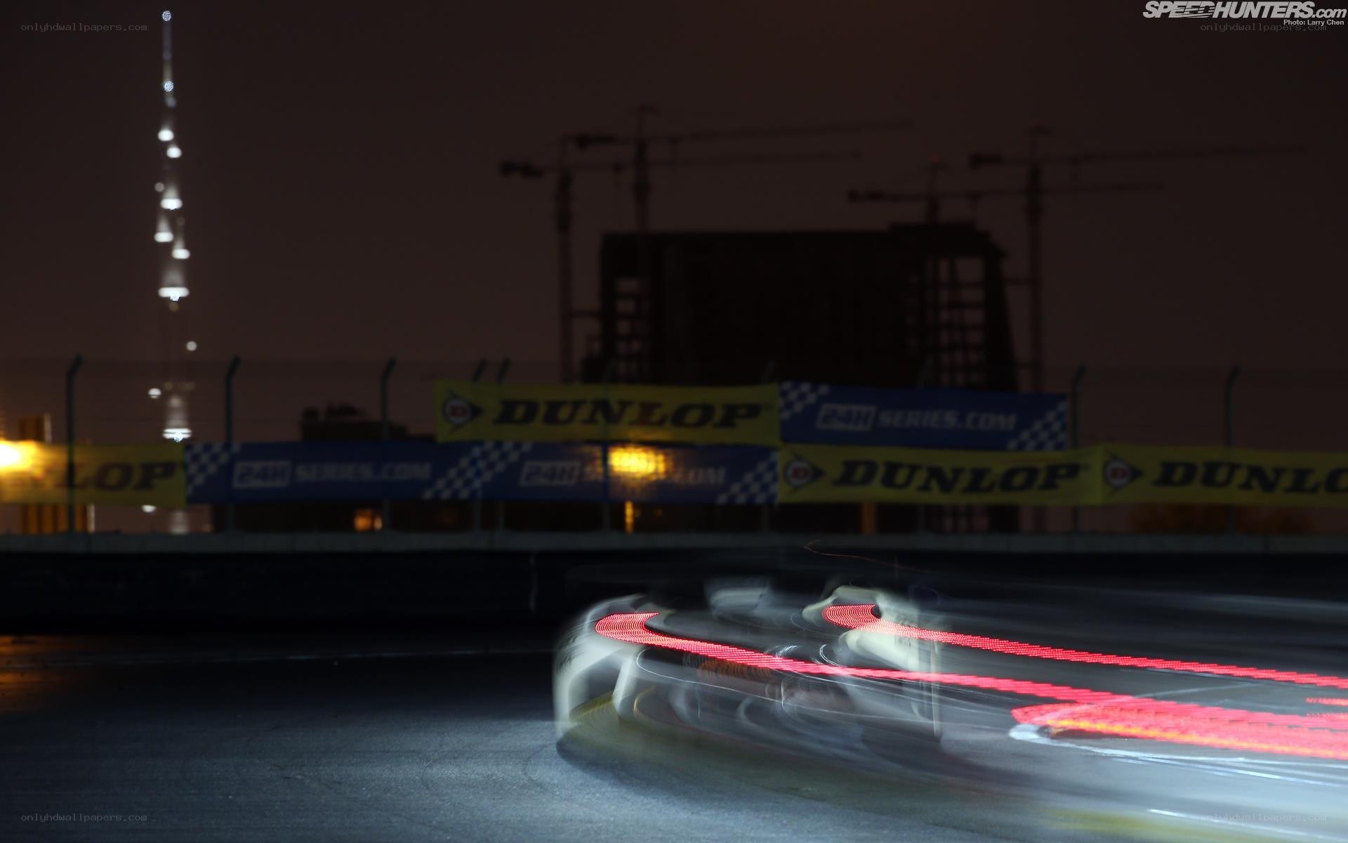 Car racing at night with light trails