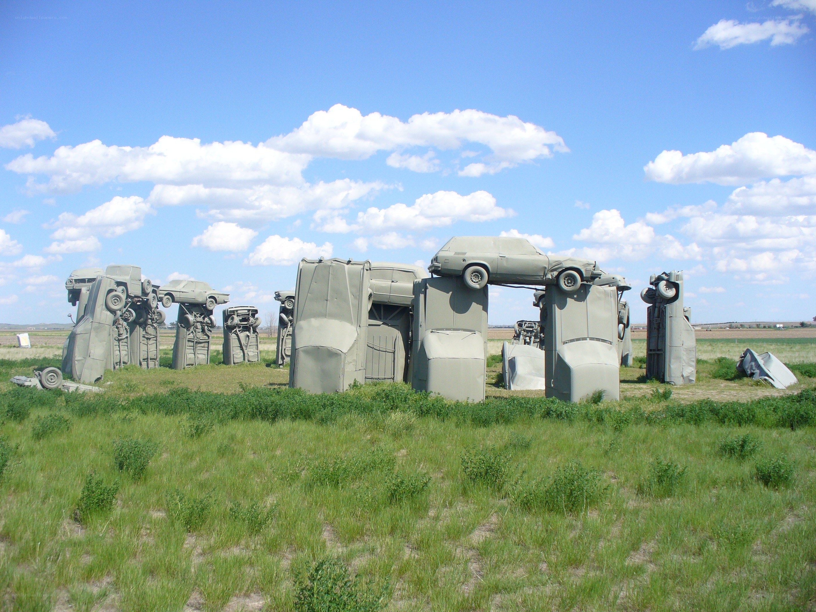 Car sculpture installation in field
