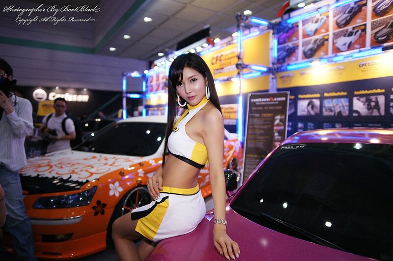 Car show model posing with cars
