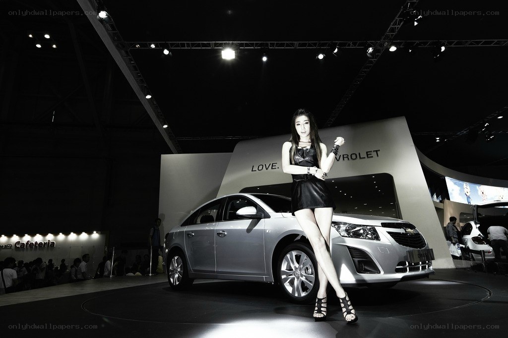Car show model posing with sedan