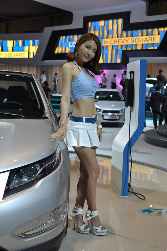Car show model posing with vehicle