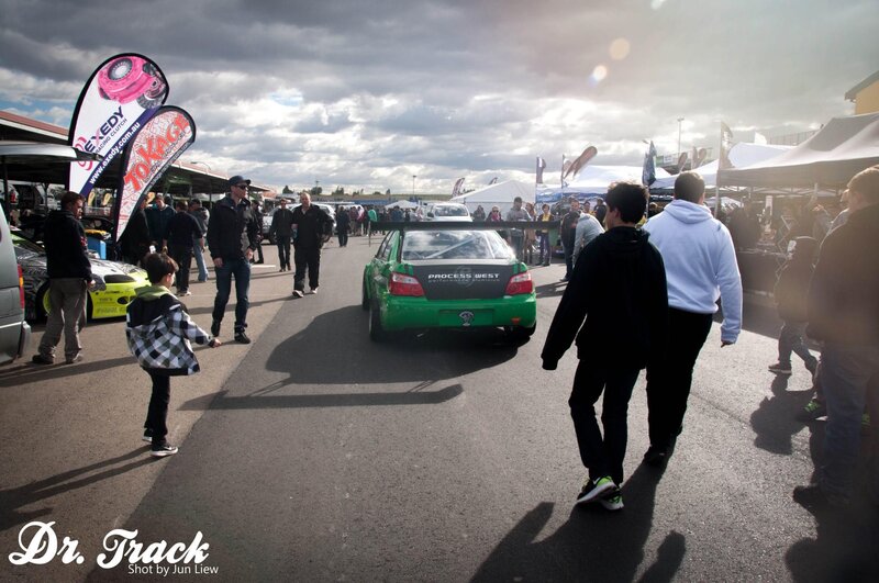 Car show with green race car