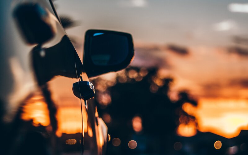 Car Side Mirror at Sunset