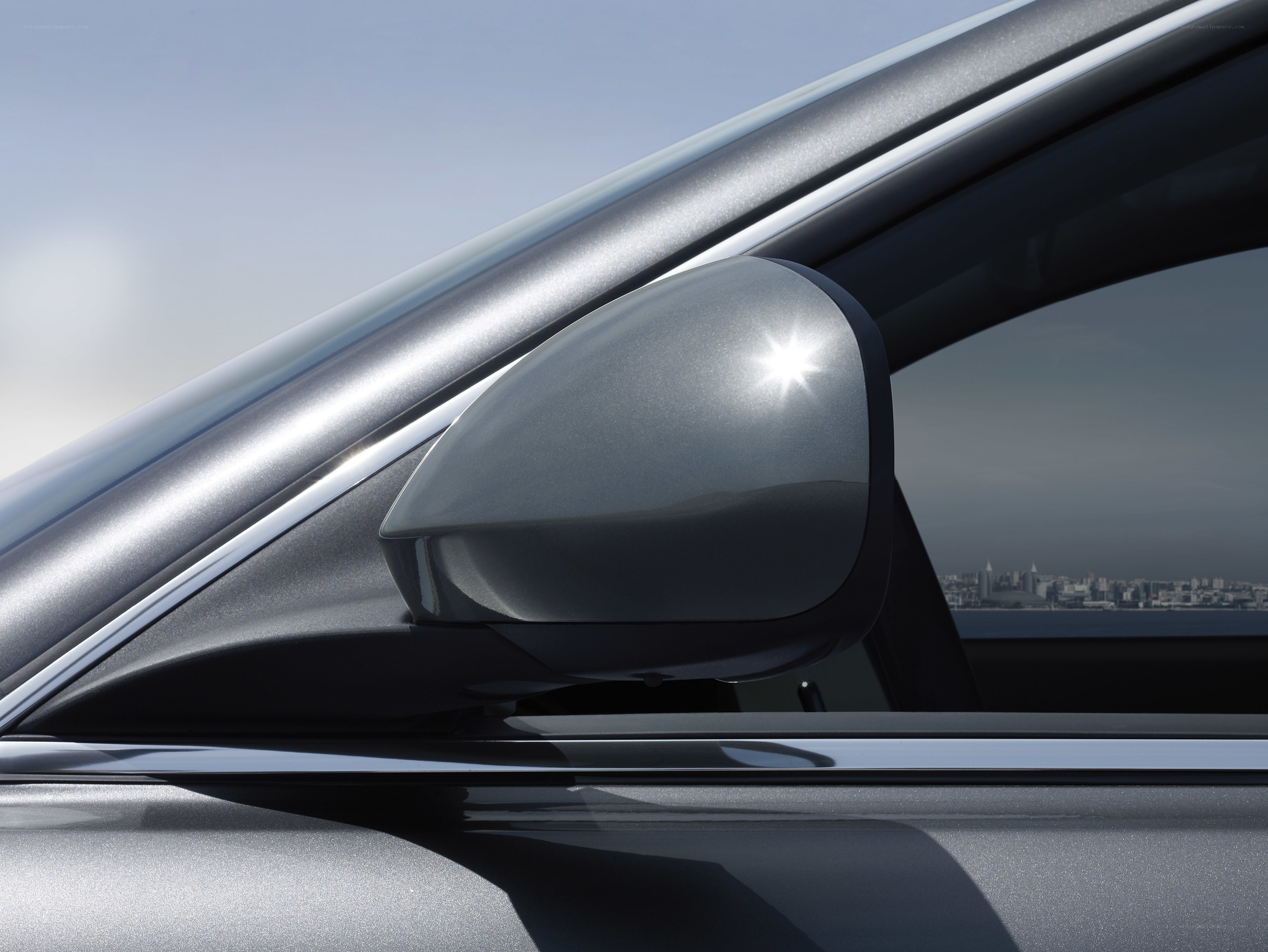 car side mirror with city view