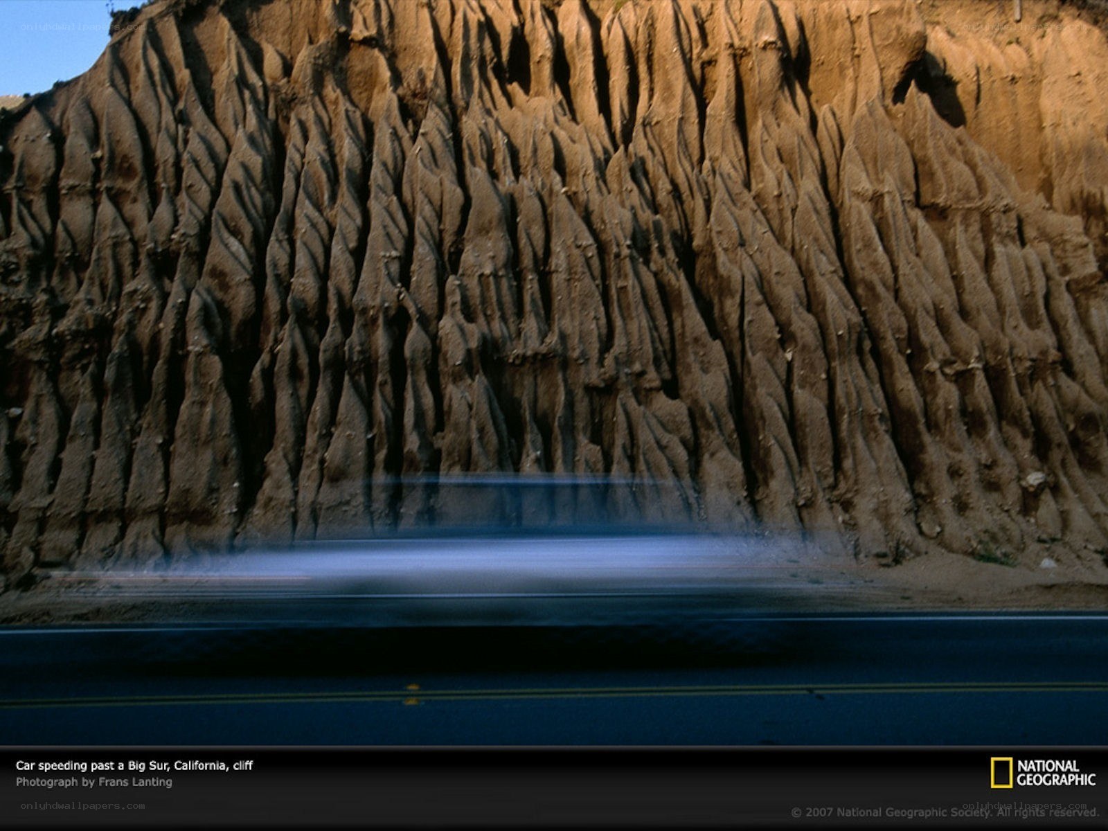 Car speeding past Big Sur cliff