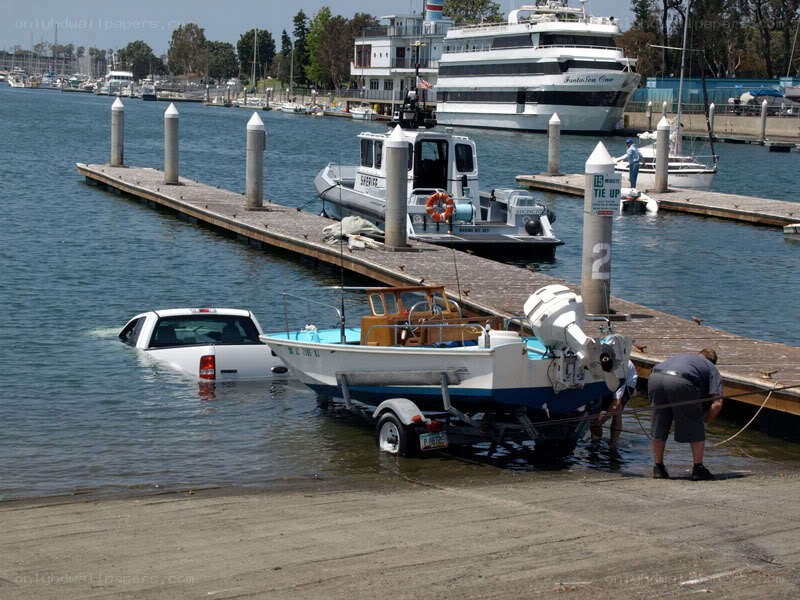 Car submerged at marina dock