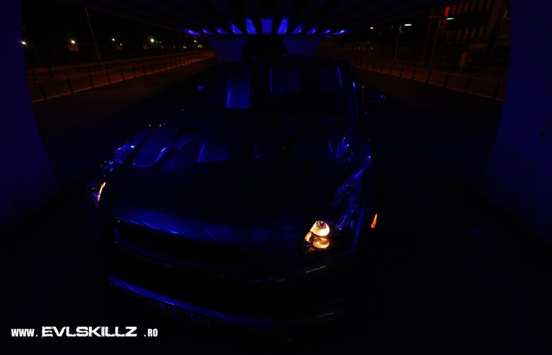 car under bridge at night