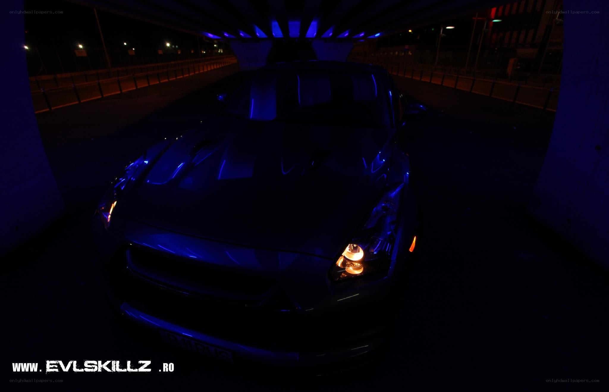 car under bridge at night