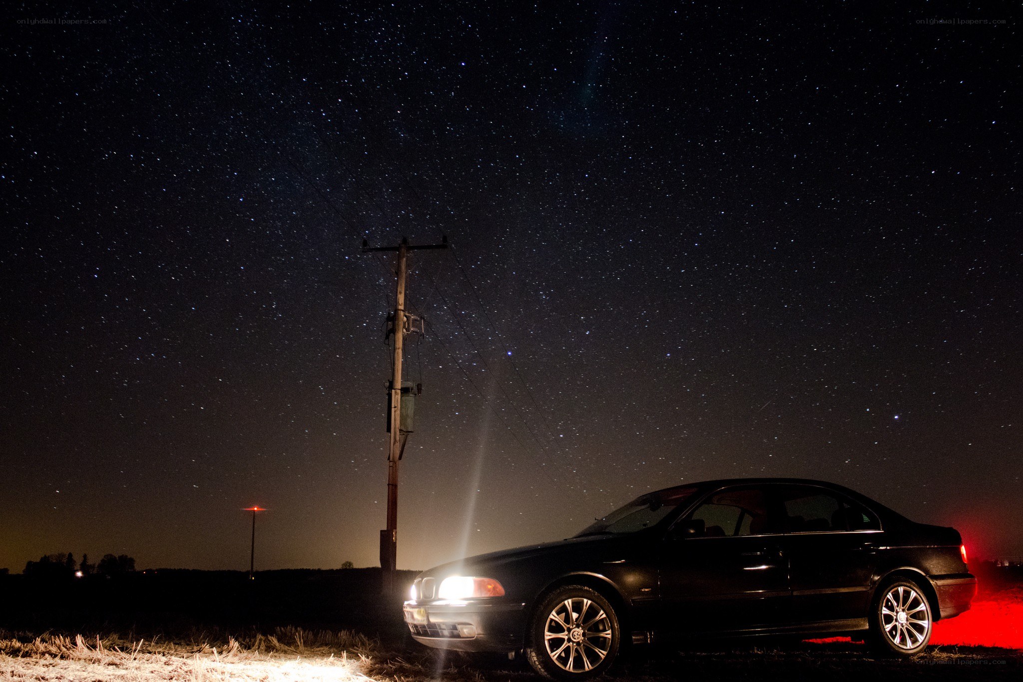 Car under starry night sky