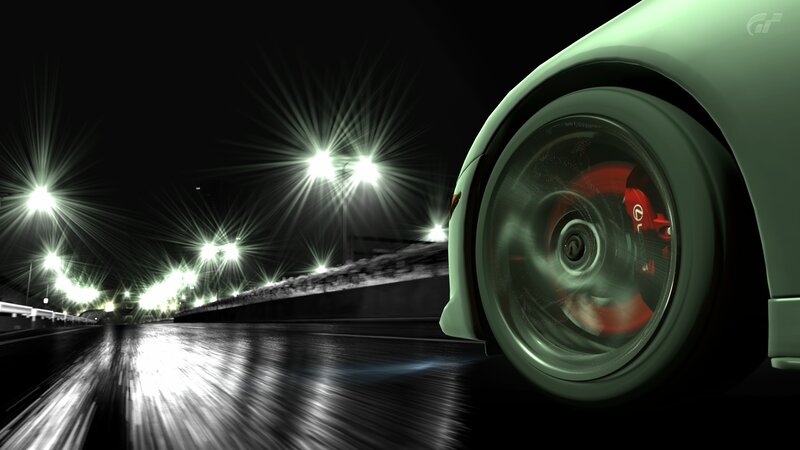 car wheel at night on wet road