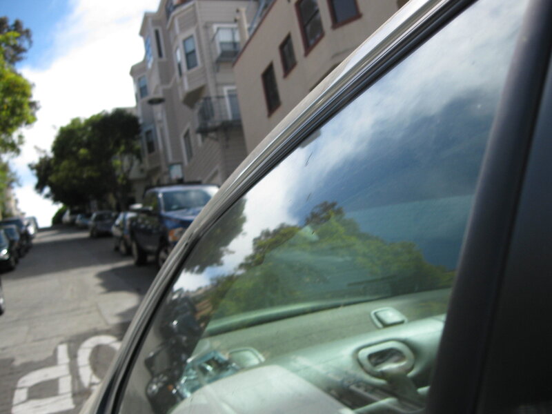 car window reflecting street scene