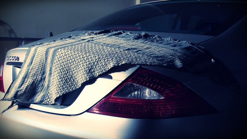 Car with blanket on trunk