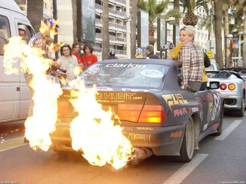Car with flames on street