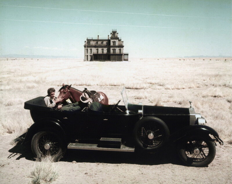 Car with horse in desert