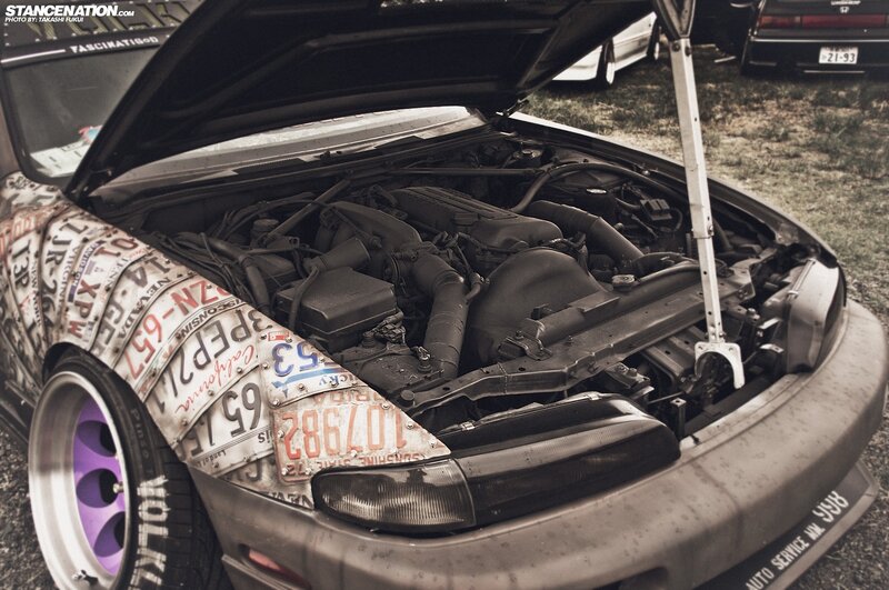 car with open hood and license plate wrap
