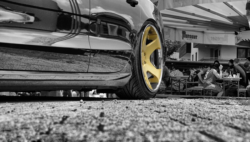 car with yellow wheel at outdoor event