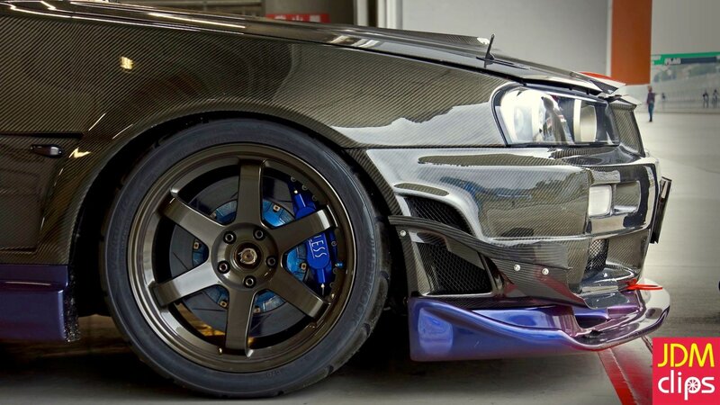 carbon fiber car with blue brakes