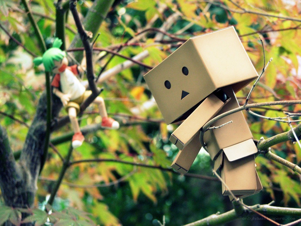Cardboard box figures in a tree