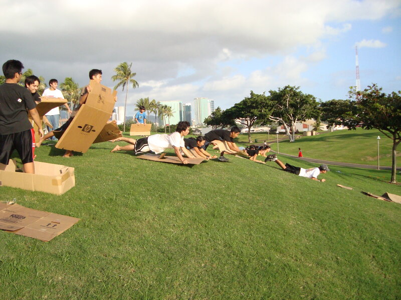 Cardboard box race on a grassy hill