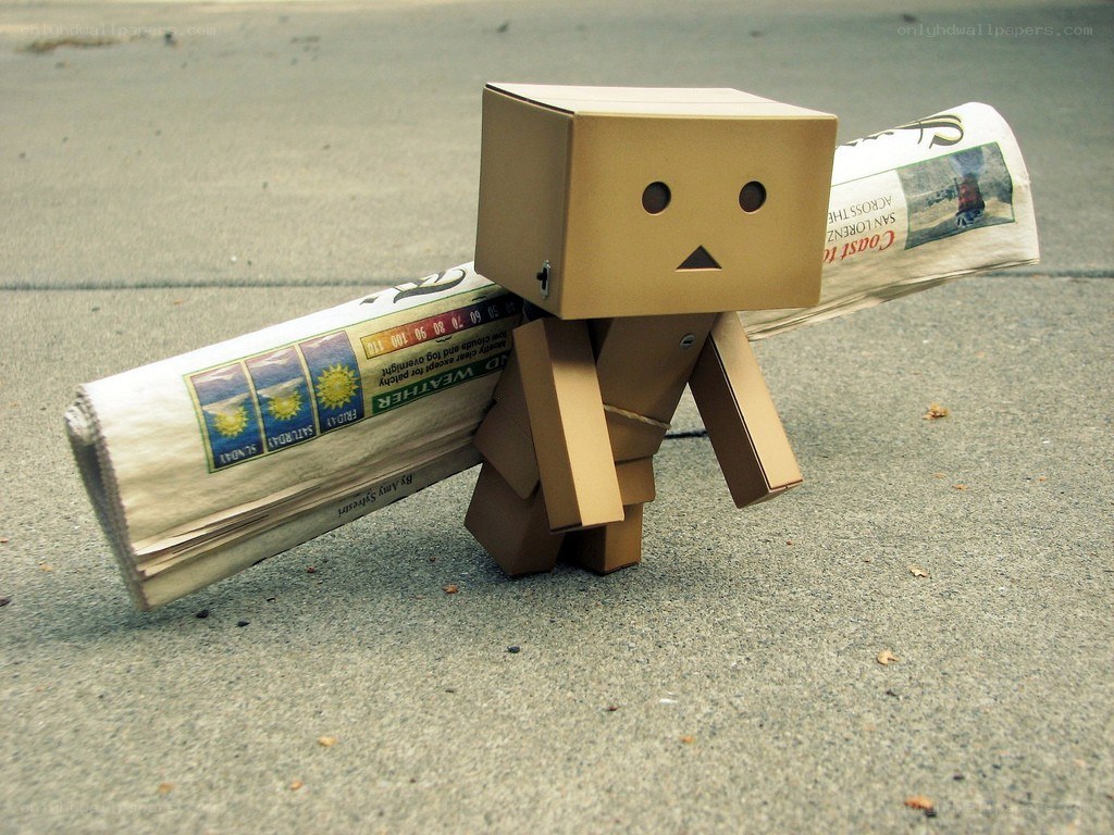 cardboard figure with newspaper