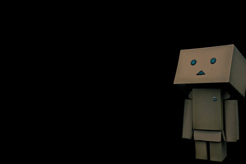 Cardboard Robot Figure — Black, Dramatic, Photograph