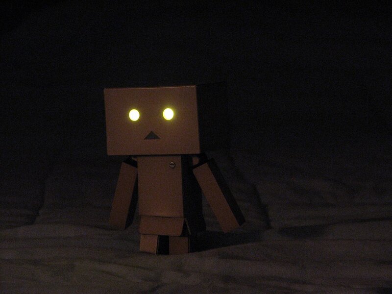 cardboard robot in darkness