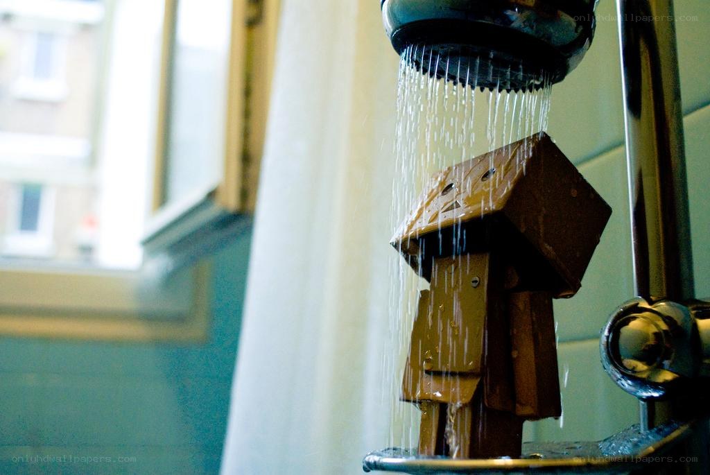 cardboard robot under shower