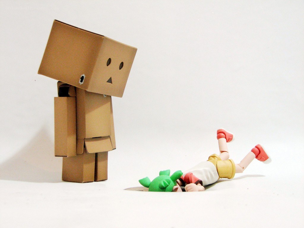 Cardboard robot with fallen figure