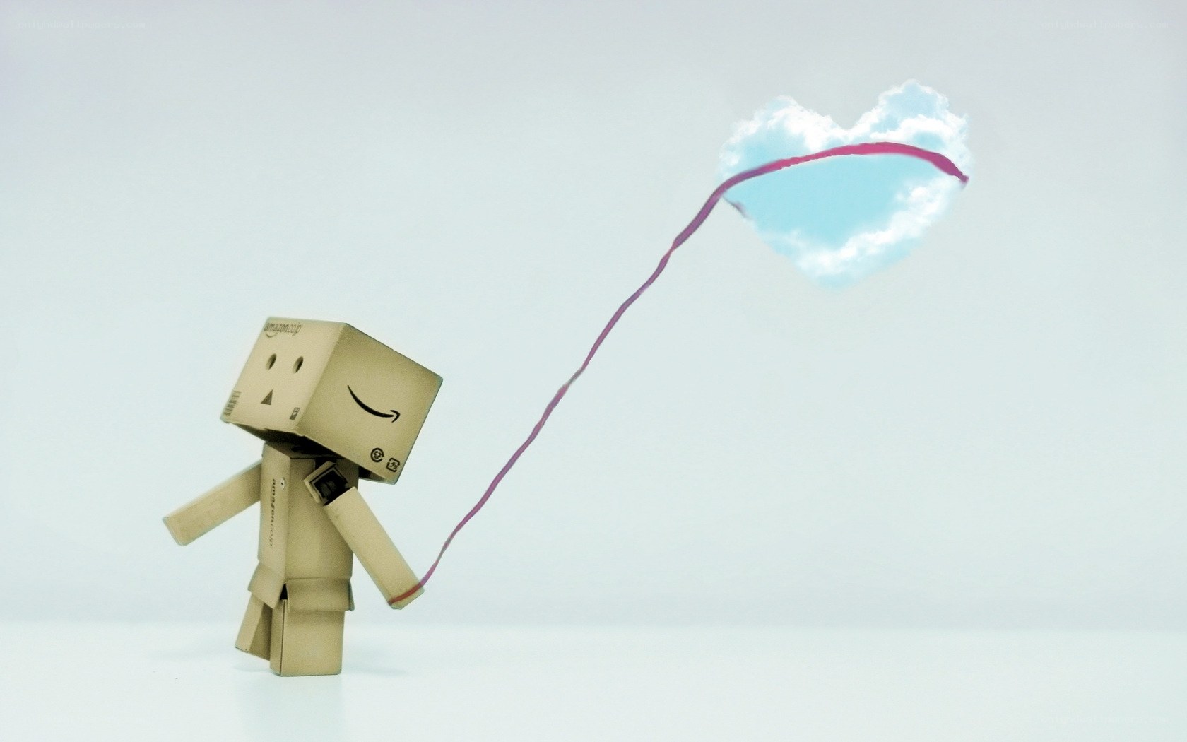 cardboard robot with heart-shaped cloud